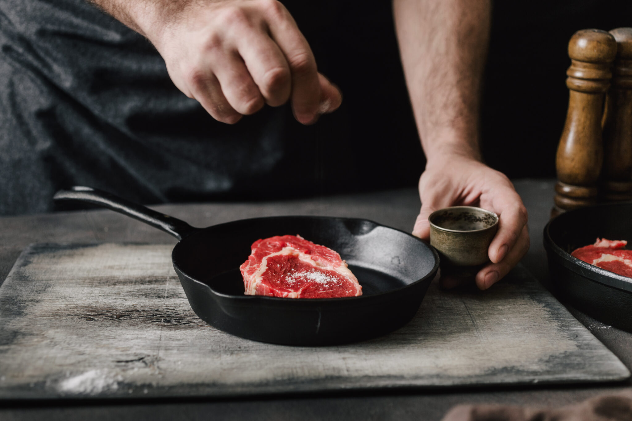 Man Cooking Beef Steaks On The Home Kitchen Man Cooking Beef Steaks On The Home Kitchen
