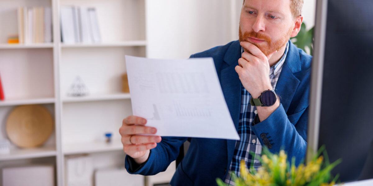 Businessman Doing Paperwork While Working In An Office Businessman Doing Paperwork While Working In An Office